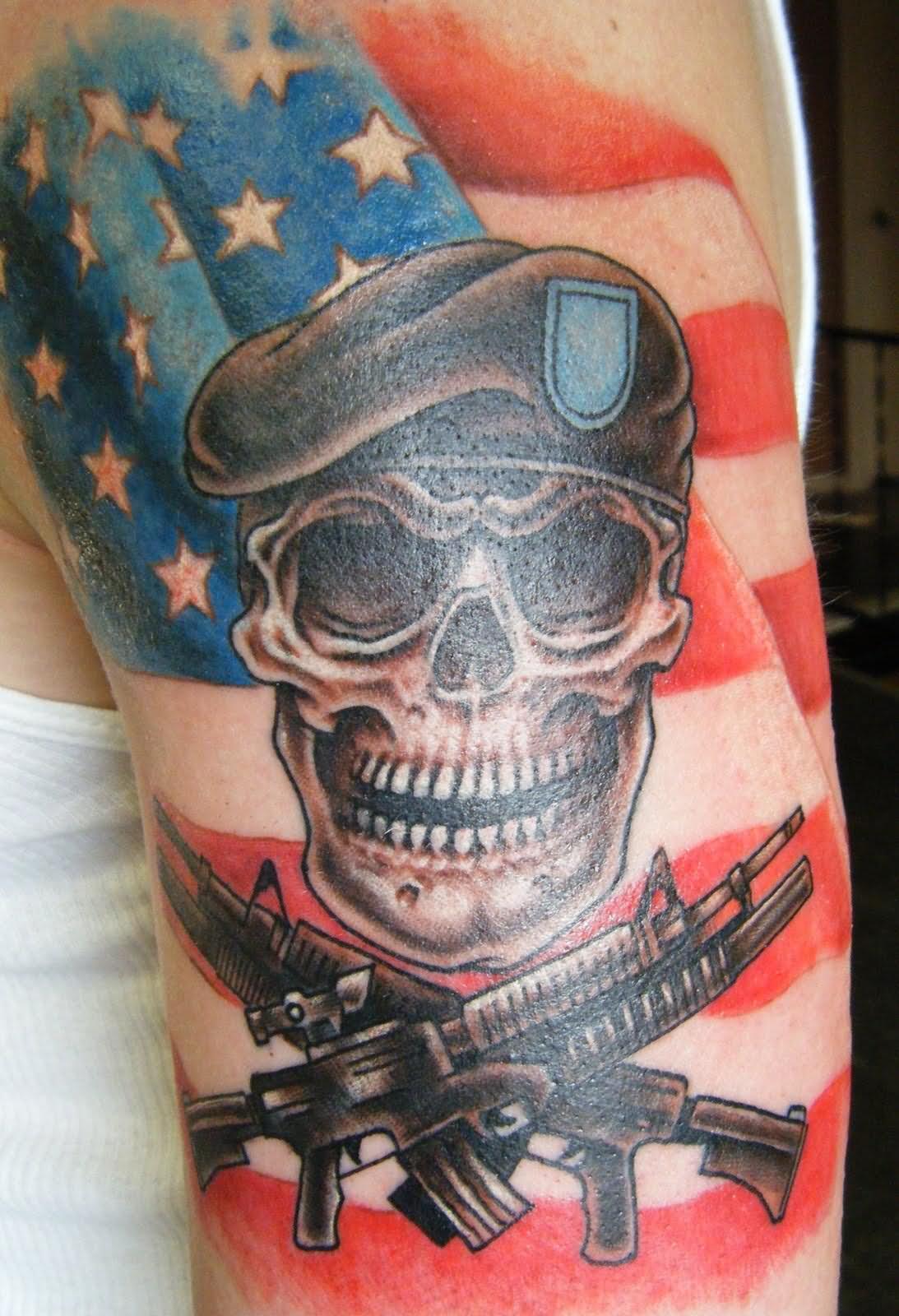 Army Skull With Two Crossing Guns And USA Flag Tattoo On Left Shoulder
