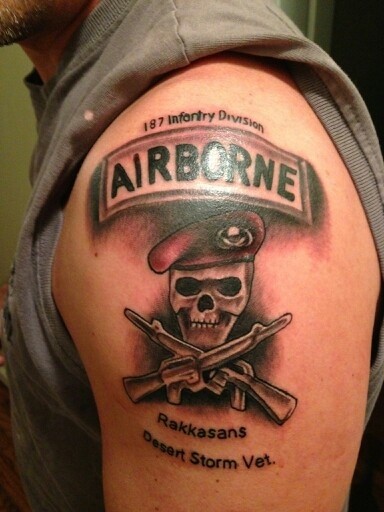 Army Skull With Two Crossing Guns Tattoo On Man Left Shoulder