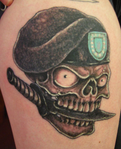 Black Ink Army Skull Holding Dagger In Teeth Tattoo Design For Shoulder