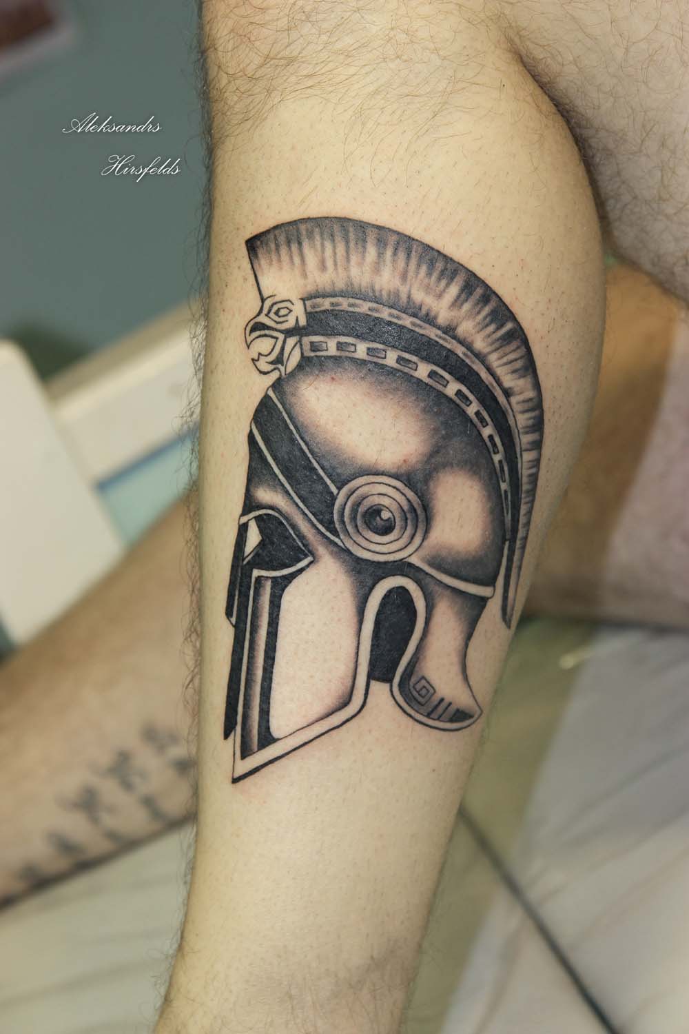 Black Ink Warrior Helmet Tattoo On Leg
