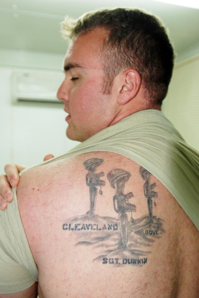 Grey Ink Army Equipments Tattoo On Man Left Back Shoulder