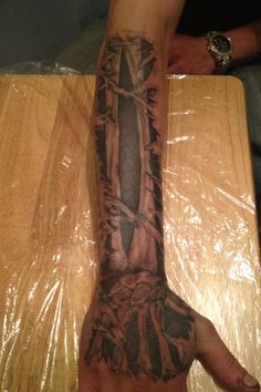 Attractive Ripped Skin Bone Tattoo On Arm