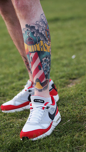 Beautiful Colored Lighthouse Tattoo On Left Leg