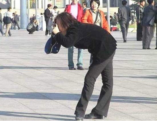 Bent Over Girl Taking Photo Funny Image