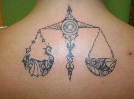 Black And Grey Tribal Tattoo On Upper Back