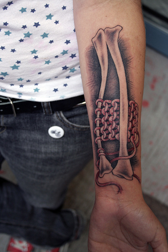 Black Ink 3D Bone Tattoo On Forearm