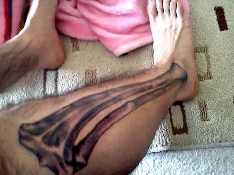 Black Ink Bone Tattoo On Right Leg