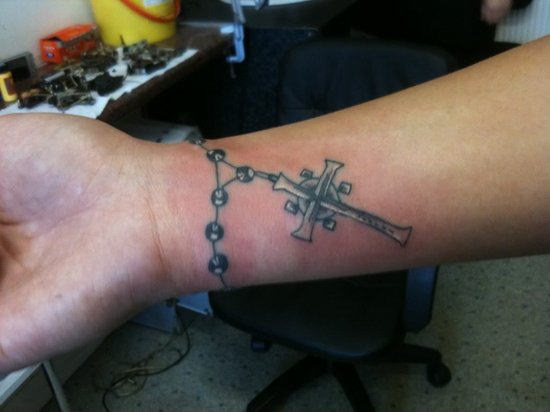 Black Ink Christian Rosary Cross Tattoo On Wrist