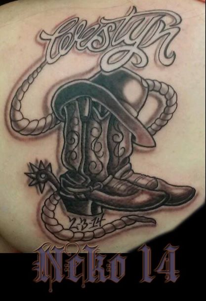Black Ink Cowboy Boot With Hat And Rope Tattoo Design