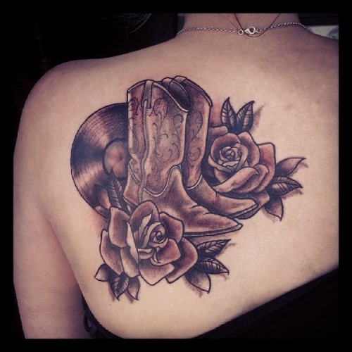 Black Ink Cowboy Boot With Roses Tattoo On Left Back Shoulder