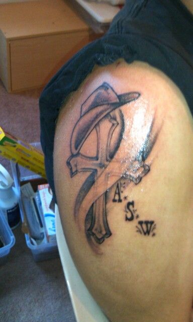 Black Ink Cross With Cowboy Hat Tattoo On Right Shoulder