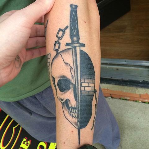 Black Ink Dagger In Skull Tattoo Design For Arm