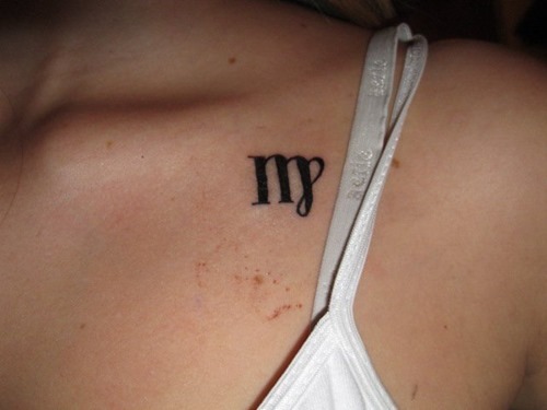 Black Ink Virgo Zodiac Symbol Tattoo On Collarbone