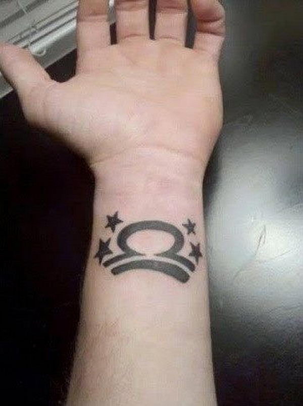 Black Stars And Libra Zodiac Sign Tattoo On Left Wrist