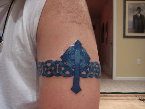 Blue Ink Celtic Cross Tattoo On Left Half Sleeve