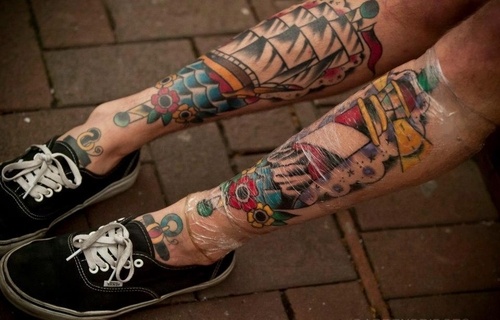 Color Flowers With Ship And Lighthouse Tattoo On Legs