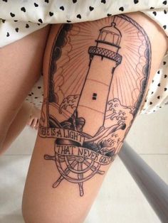 Compass Wheel And Lighthouse Tattoos On Thigh