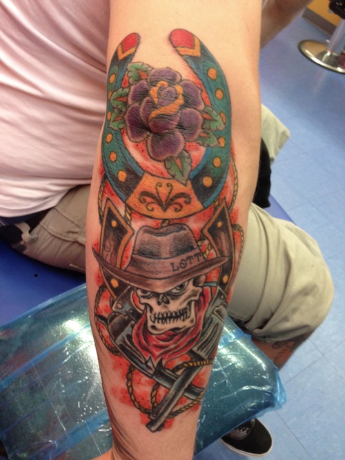 Read Complete Cowboy Skull With Two Guns With Horseshoe Tattoo On Full Sleeve