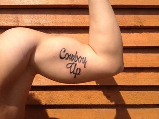Cowboy Up Lettering Tattoo On Bicep