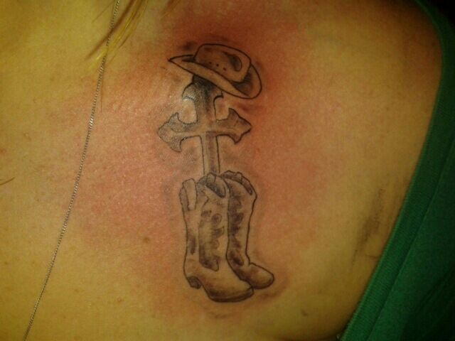 Grey Ink Cross With Hat And Boot Tattoo Design