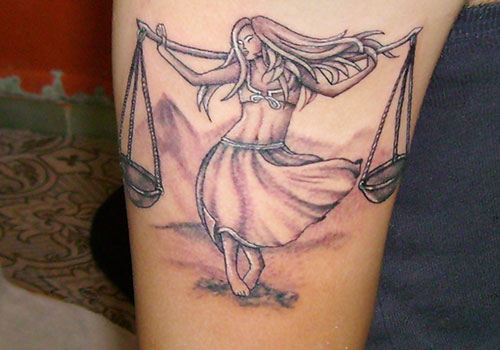 Grey Ink Libra Girl With Scale Tattoo On Right Bicep