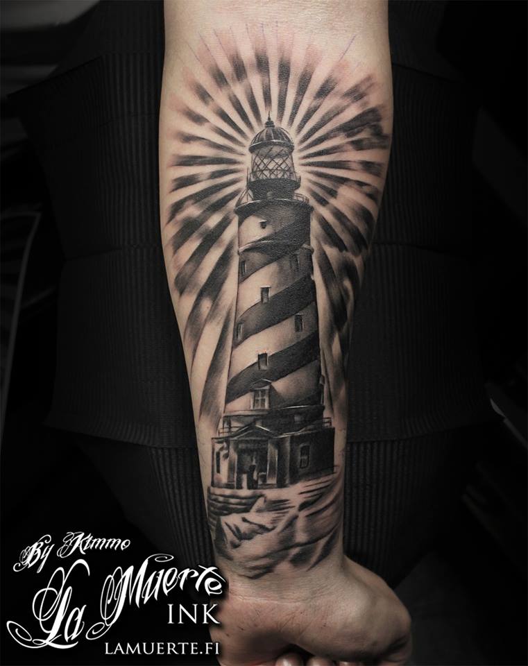 Guy Showing His Lighthouse Tattoo On Forearm