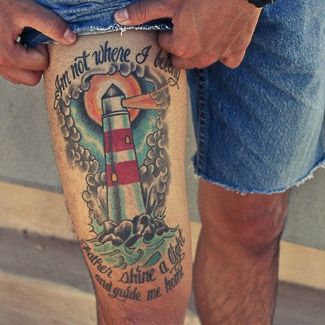 Guy Showing His Lighthouse Tattoo On Right Leg