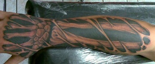 Ripped Skin Bone Tattoo On Arm