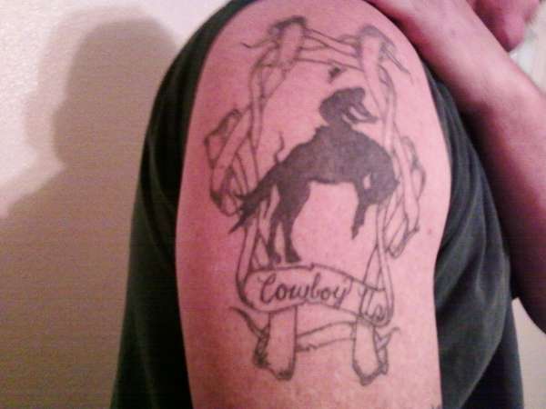 Silhouette Cowboy Riding Horse With Banner Tattoo On Right Shoulder