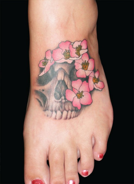 Skull Bone With Flowers Tattoo On Girl Foot