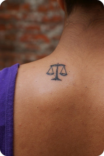 Tiny Libra Scales Tattoo On Left Back Shoulder