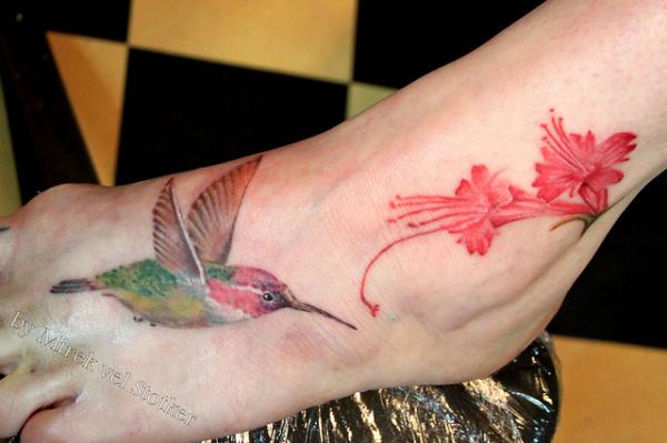 Amazing Colorful Flying Hummingbird Tattoo On Foot