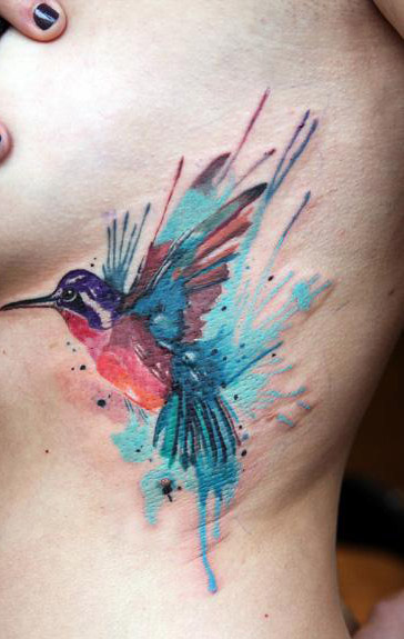 Awesome Watercolor Hummingbird Tattoo On Girl Side Rib