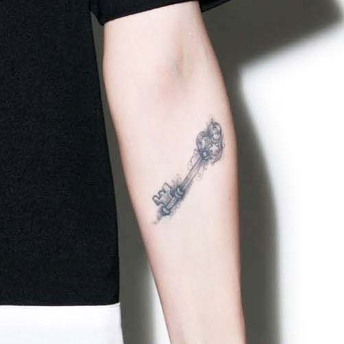 Black And Grey Key Tattoo On Forearm