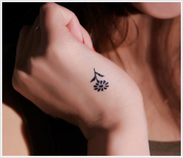 Black Daisy Flower Tattoo On Girl Hand