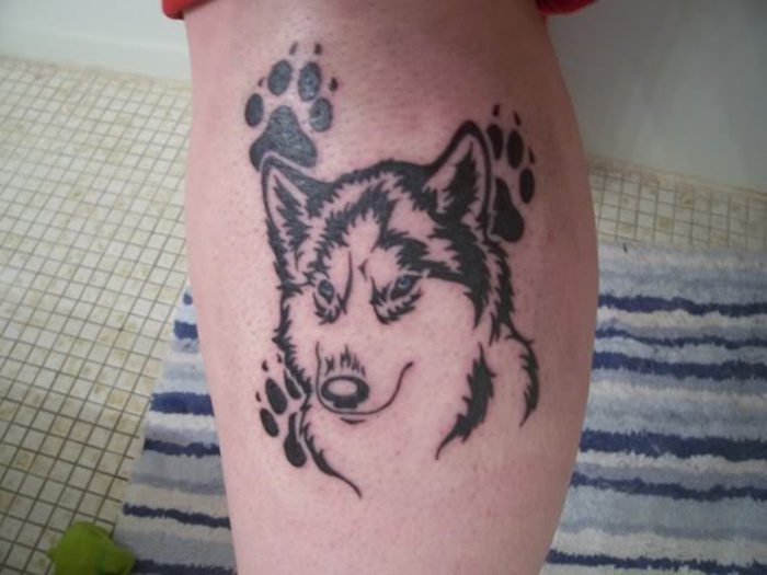 Black Dog Face With Paw Print Tattoo On Leg Calf