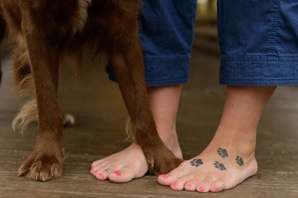 Black Dog Paw Prints Tattoo On Girl Foot