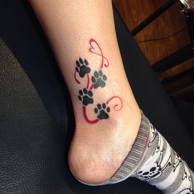 Black Four Dog Paw Print Tattoo On Leg