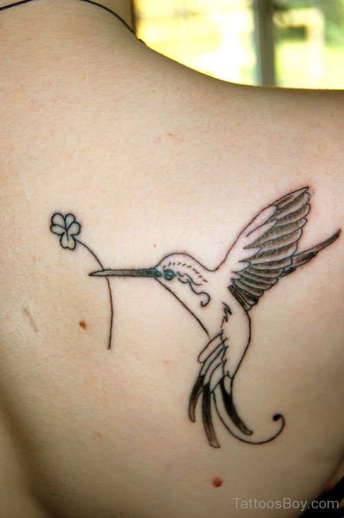 Black Ink Clover Leaf In Beak Hummingbird Tattoo On Right Back Shoulder