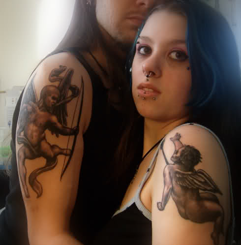 Black Ink Cupid Cherub Tattoo On Couple Shoulder