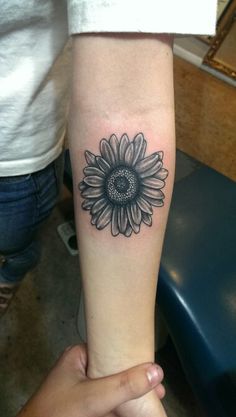 Black Ink Daisy Flower Tattoo On Forearm