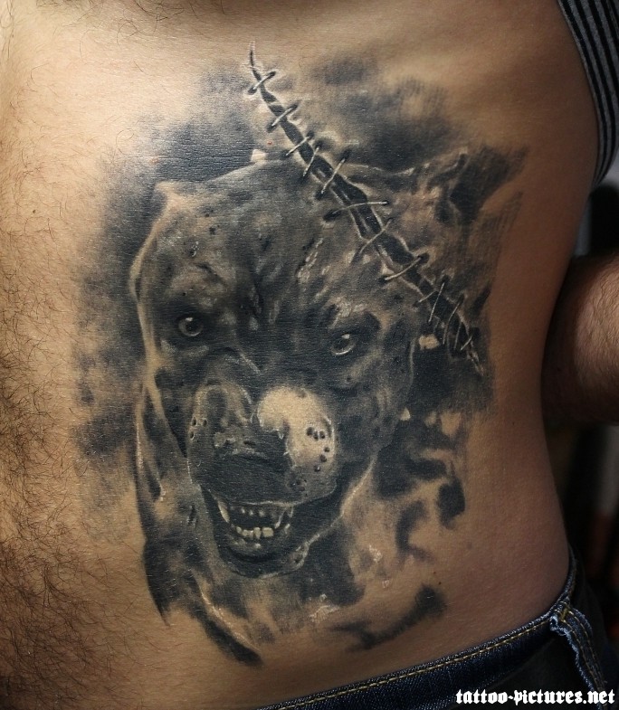 Black Ink Dog Face Tattoo On Man Stomach