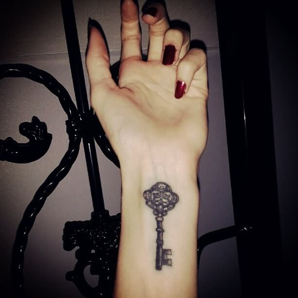 Black Ink Key Tattoo On Girl Wrist