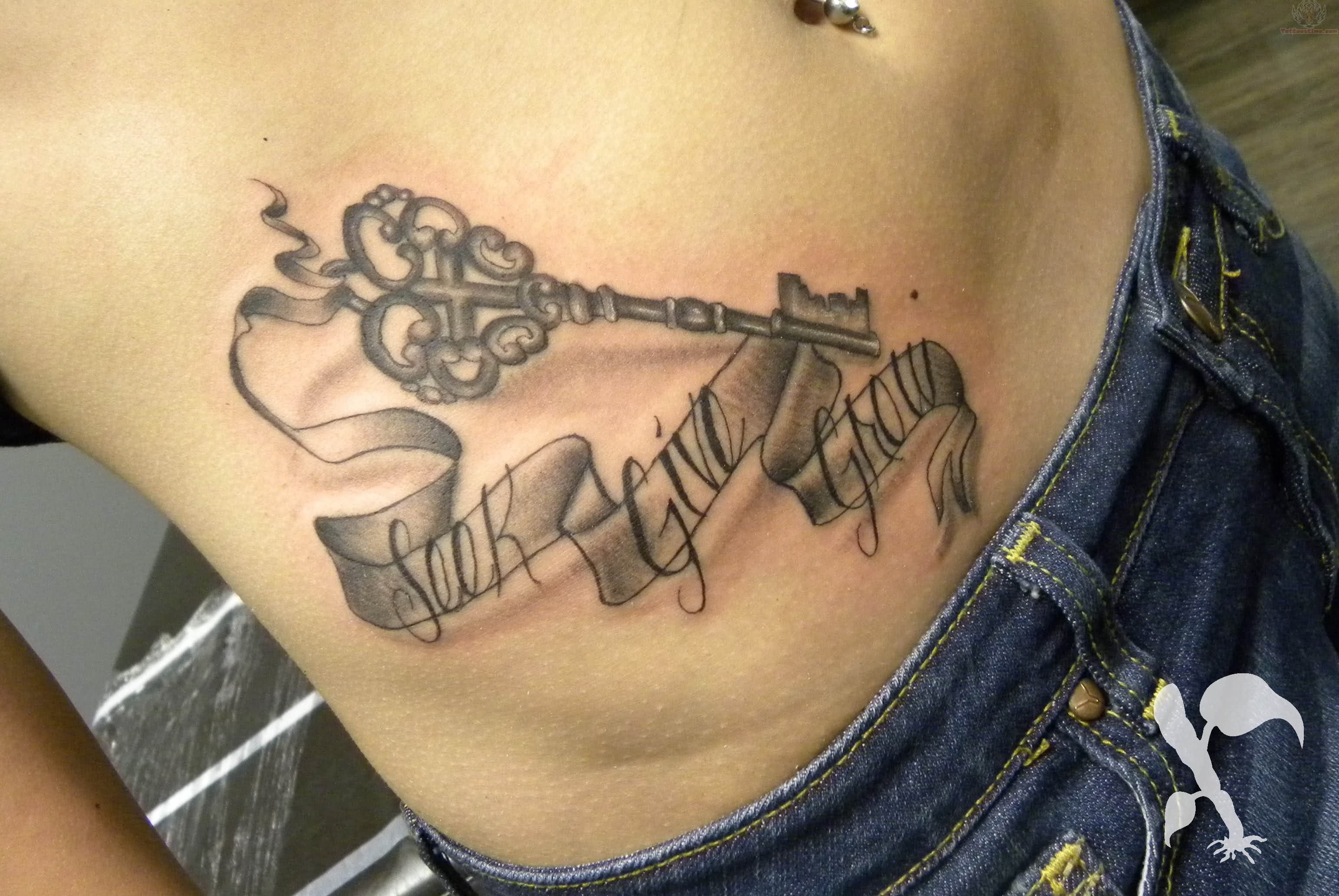 Black Ink Key With Banner Tattoo On Hip