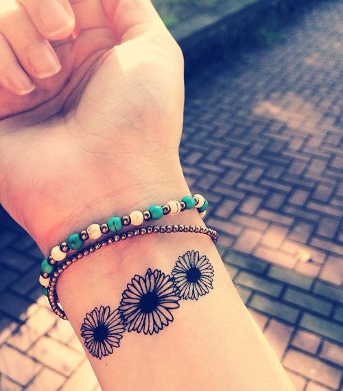 Black Little Daisy Flowers Tattoo On Wrist