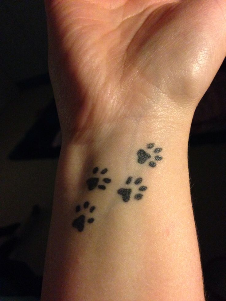 Black Little Four Dog-Paw Print Tattoo Design For Wrist