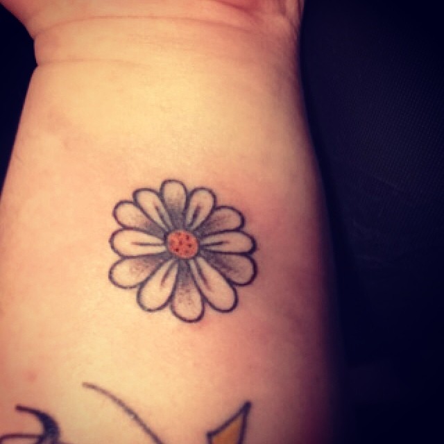 Black Outline Daisy Flower Tattoo Design For Wrist