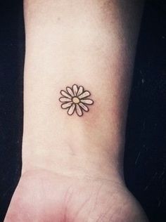 Black Outline Little Daisy Flower Tattoo On Wrist