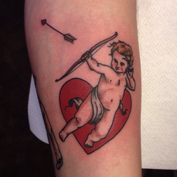 Bow And Arrow In Cupid Cherub Hand With Heart Tattoo Design For Sleeve