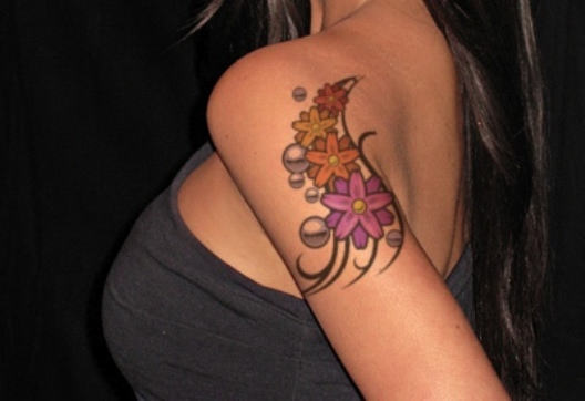 Colorful Daisy Flowers Tattoo On Girl Left Shoulder